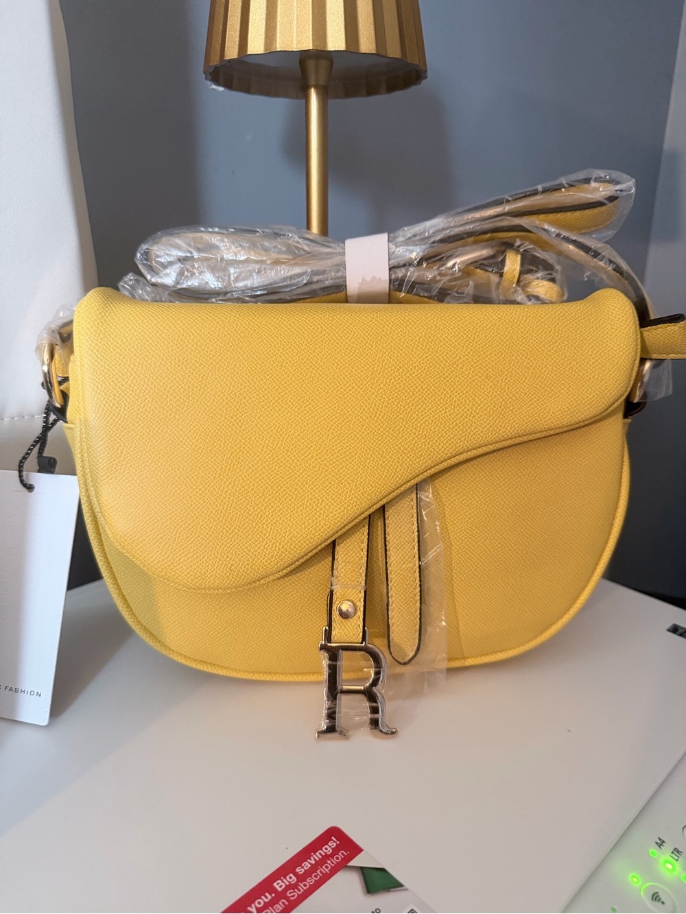 Yellow Crossbody Saddle Bag with Decorative 'R' Charm
